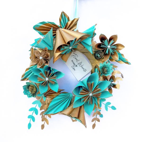 A floral paper wreath made of blue and gold flowers